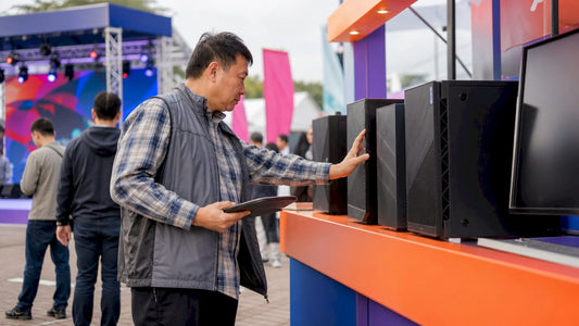 Man browsing desktop computers in retail showroom