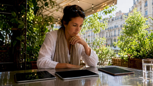 Woman testing three tablets side by side in café